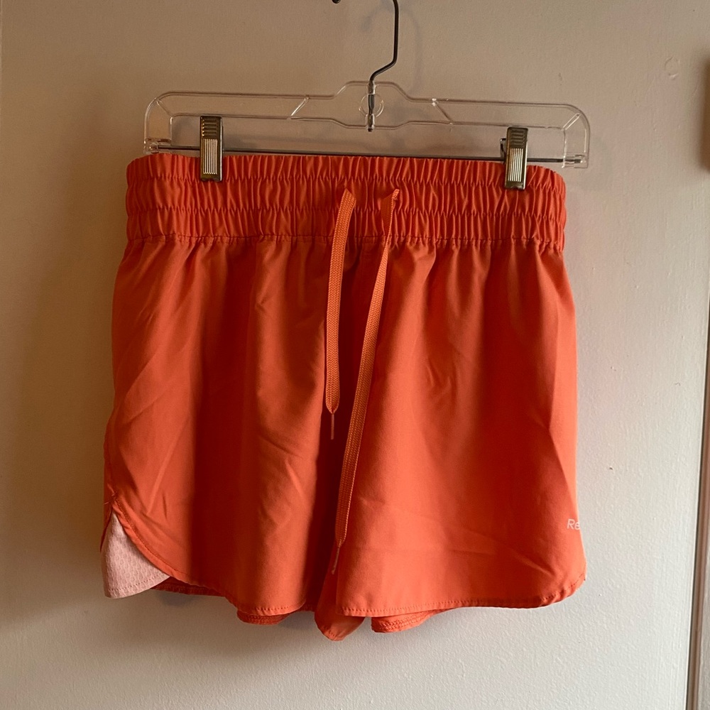 *Reebok peach / orange running shorts, size large